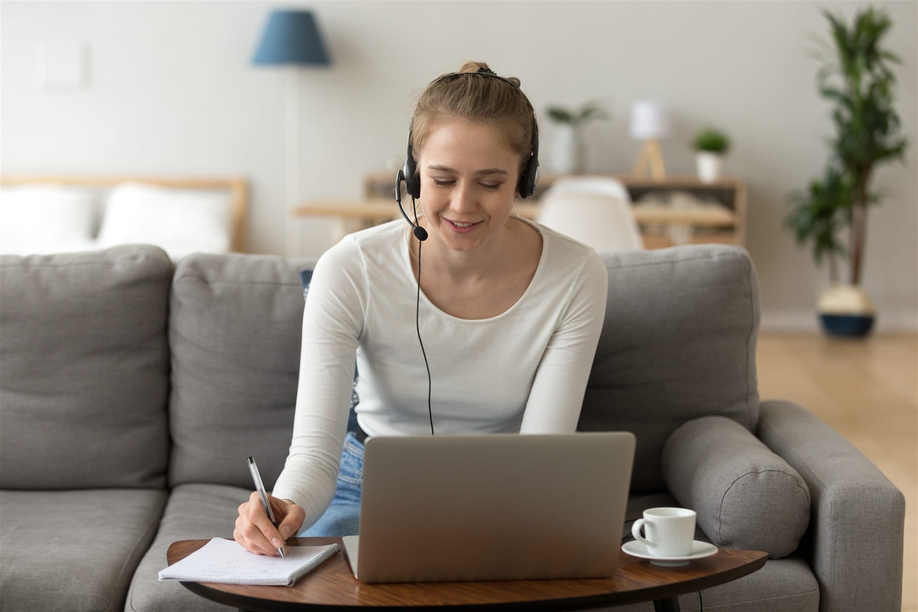Instructor care susține o lecție online folosind un laptop și căști