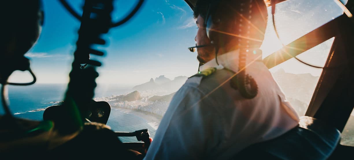 Helicopter pilot wearing a headset in the cockpit